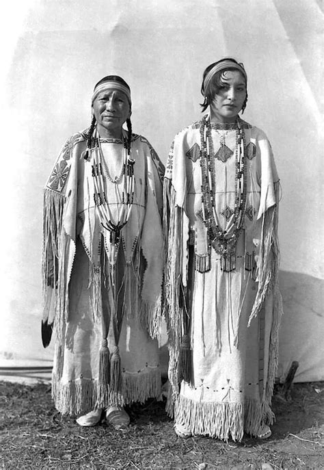 Two Native American Women Standing Next To Each Other