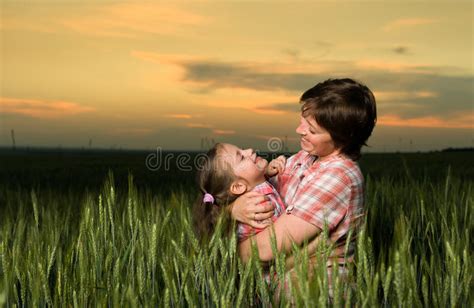Happy Mother And Child In Green Field At Sunset Stock Photo Image Of