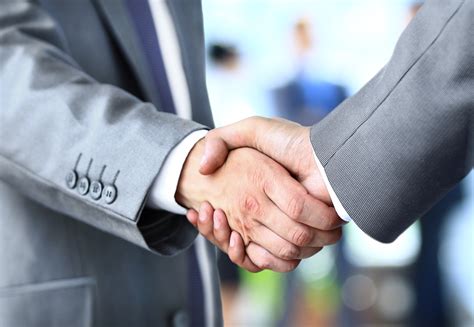 handshake in office - Insurance2day Insurance Services Ltd