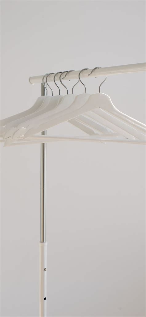 White Clothes Hangers Hanging On Rack Iphone 12 Wallpapers Free Download