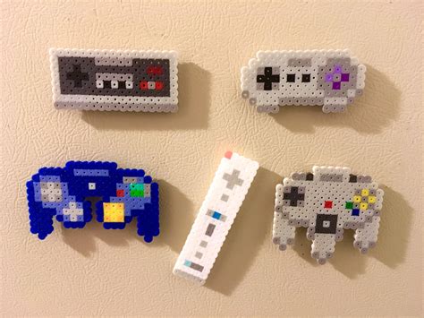 Four Pieces Of Pixel Art Are Arranged On A Wall Each With An Old Video