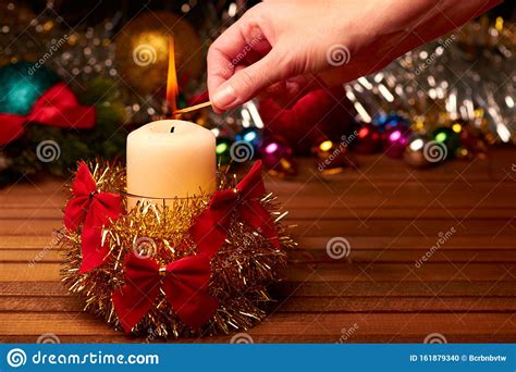 New Year`s Still Life. The Human Hand Lights A Candle Against Th Stock ...