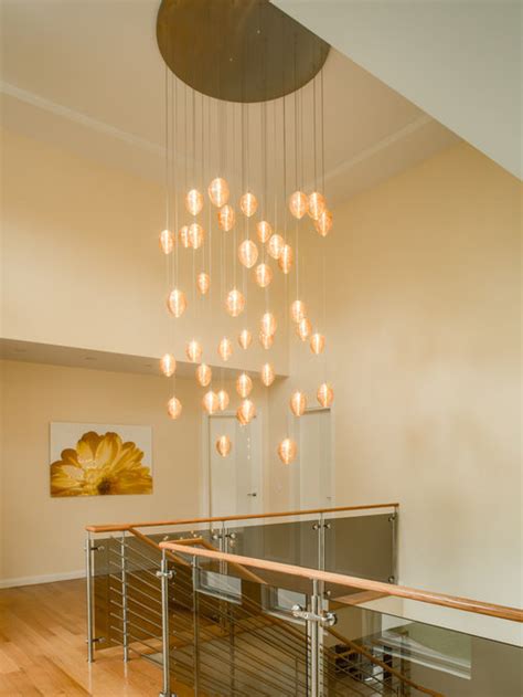 Installing many light sources on a single track allows for increased. COCOON | Custom Stairwell Chandelier | Blown Glass Vaulted ...