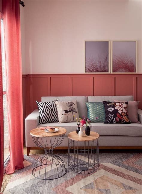 A Living Room With Pink Walls And Furniture In The Corner Including A