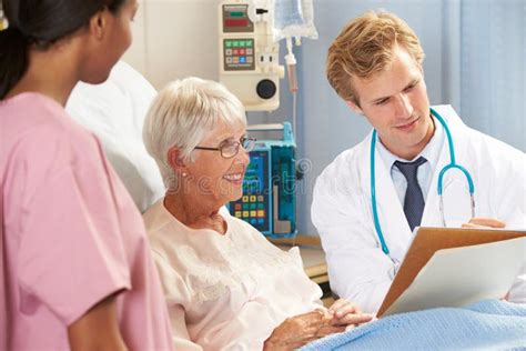 Doctor With Nurse Talking To Senior Female Patient In Bed Stock Image Image Of Patient