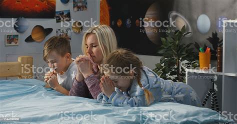 Mother And Children Praying Together Stock Photo - Download Image Now 