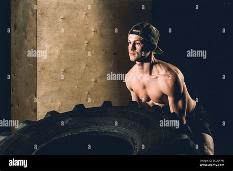 Crossfit Training Man Flipping Tire In Gym Stock Photo Alamy