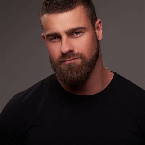 A Man With A Beard And Black Shirt