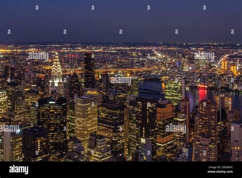 Panorama Of Manhattan Skyline At Night With An Illuminated Chrysler