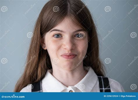 Portrait Of A Smiling School Young Beautiful Girl With Big Blue Eyes