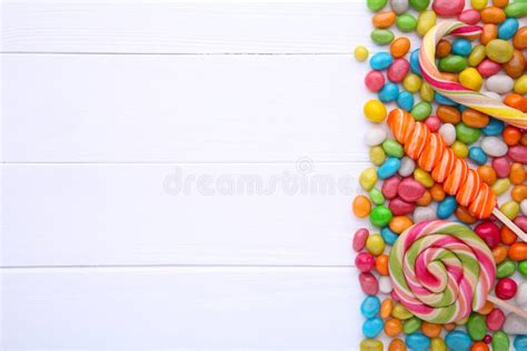 Colorful Lollipops And Different Colored Round Candy On White