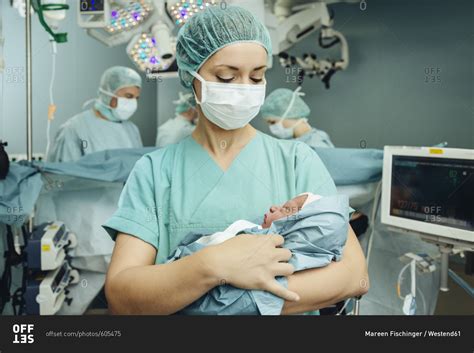 Operating Room Nurse Holding Newborn In Operating Room Stock Photo Offset