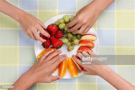 Hands Grabbing Snacks Foto E Immagini Stock Getty Images