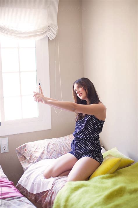 Cute Girl Taking Selfie On Bed By Ohlamour Studio