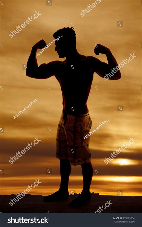 Silhouette Man Flexing His Muscles Stock Photo Edit Now 173889854