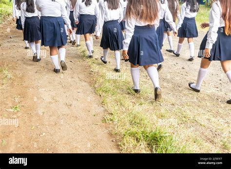 Group Of High School Student Girls Walking And Wearing Uniforms Stock