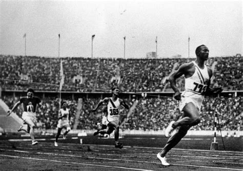 historic photos show jesse owens smashing world records at hitler s 1936 olympics