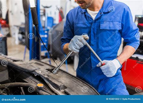 Mechanic Man With Wrench Repairing Car At Workshop Stock Photo Image
