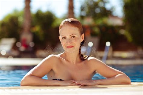 Charming Slender Red Haired Girl In A Swimsuit At The Pool In Th Stock