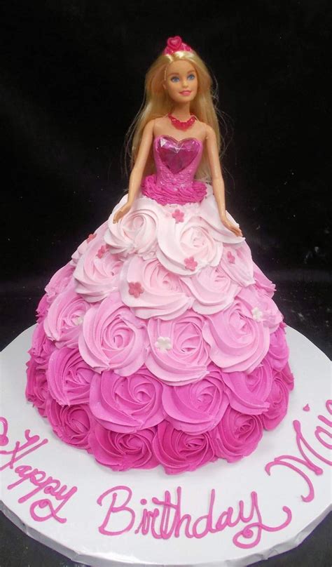 a barbie doll cake with pink icing on it