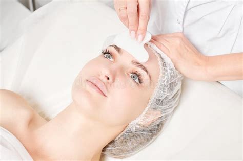 Beautician Making Facial Massage With Gua Sha Stone Of Woman Face Skin