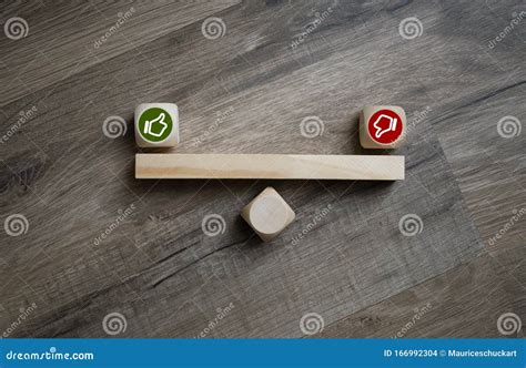 Cubes Dice With Thumbs Up And Down On Wooden Background Stock Photo