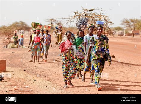 Women Arrive In The Town Of Djibo Burkina Faso On Foot Carrying