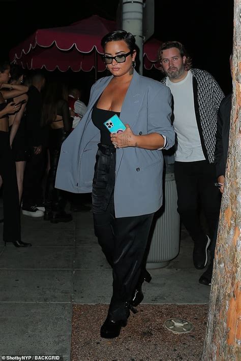 Demi Lovato Flashes Cleavage In Low Cut Top As They Enjoy A Night Out