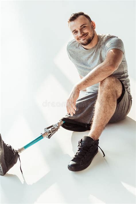 Smiling Young Man With Leg Prosthesis Looking At Camera Stock Image