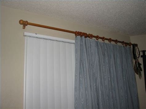 Door curtain rod is a device, devoted to suspend a blind above a doorway. How to Hang Curtains With Vertical Blinds | Hunker ...