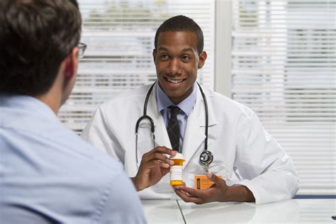 22665451 Young Black Doctor Showing Patient Prescription Horizontal