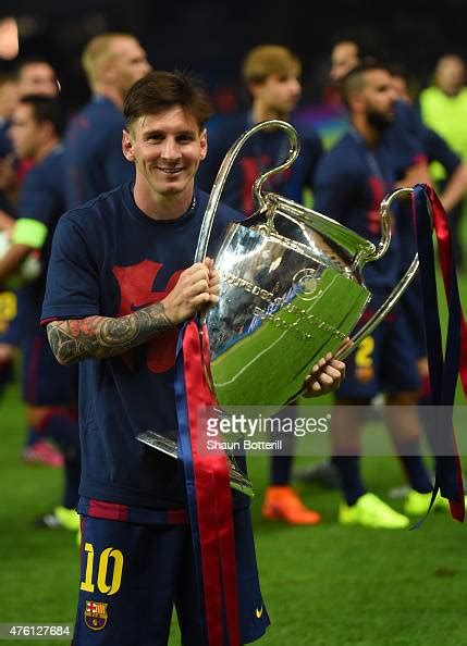 Lionel Messi Of Barcelona Celebrates With The Trophy After The Uefa