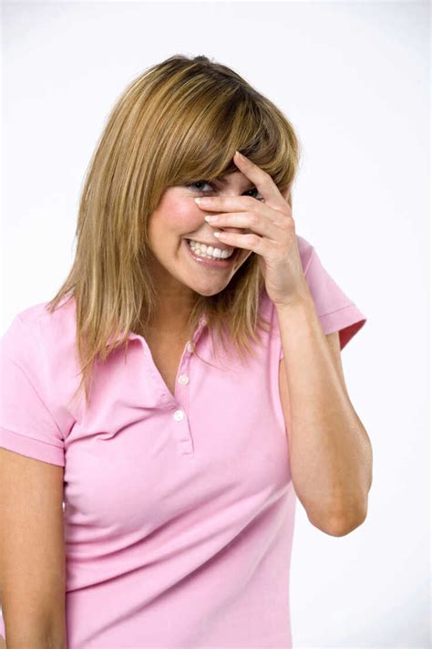 Young Woman With Hands Over Face Smiling Stock Photo