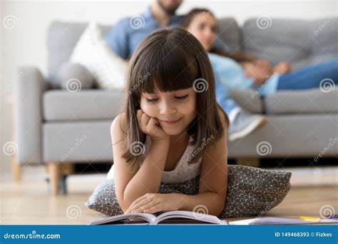 Cute Preschooler Lying On Floor Reading Interesting Book Stock Image