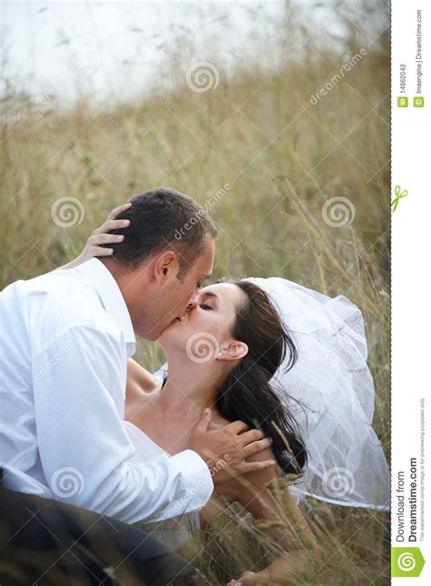 Newlyweds Kissing Wedding Portrait Stock Photo Image Of Girl Grass