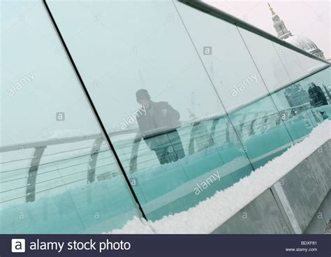 Man Walking Over The Millennium Bridge London In Snow Stock Photo Alamy