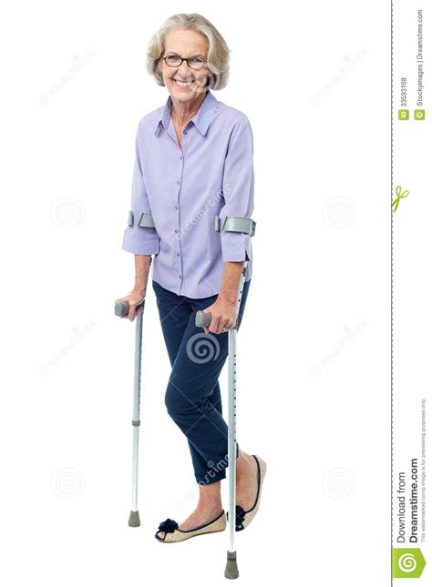 Bespectacled Old Woman Walking With Crutches Royalty Free