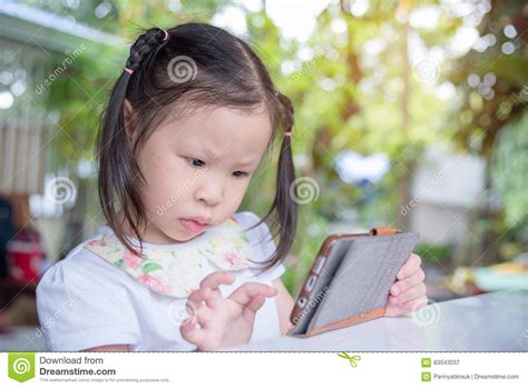 Girl Playing Game On Cellphone Stock Image - Image of cute, phone: 83543037