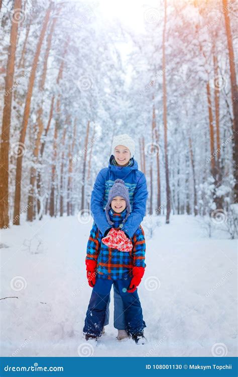 Happy Children Walking And Having Fun On Snowy Winter Day Stock Photo