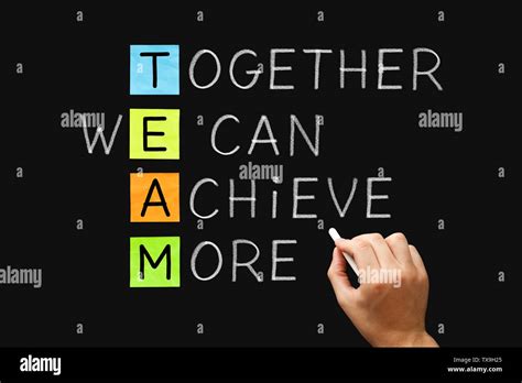 Hand Writing Team Together We Can Achieve More With White Chalk On
