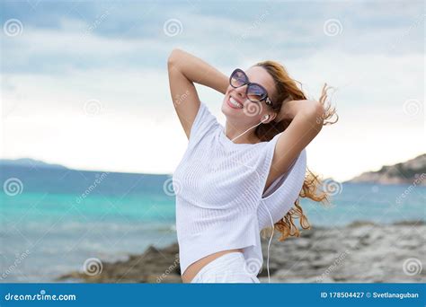 Smiling Young Woman Enjoying Her Summer Vacation On The Beach Beautiful Female Model In