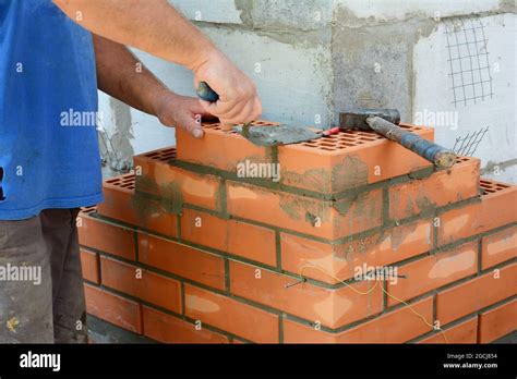 Masonry Brickwork A Masonry Contractor Is Laying The House Corner With
