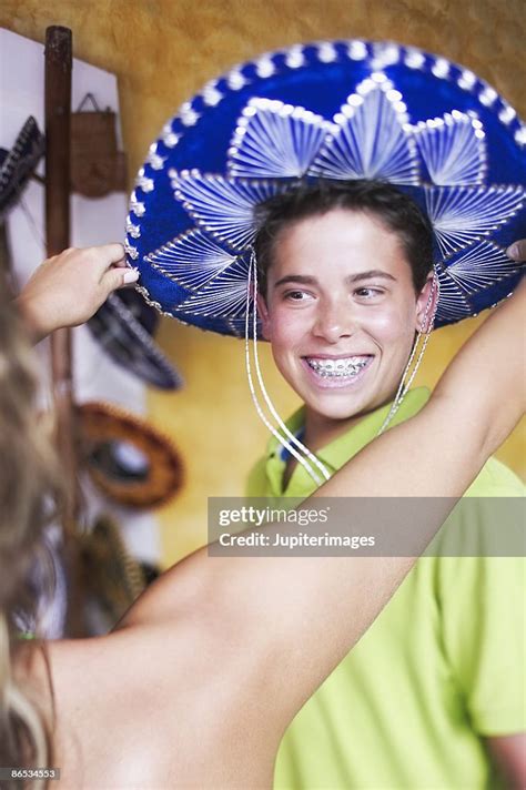 Teenage Girl Putting Sombrero On Boys Head High Res Stock Photo Getty