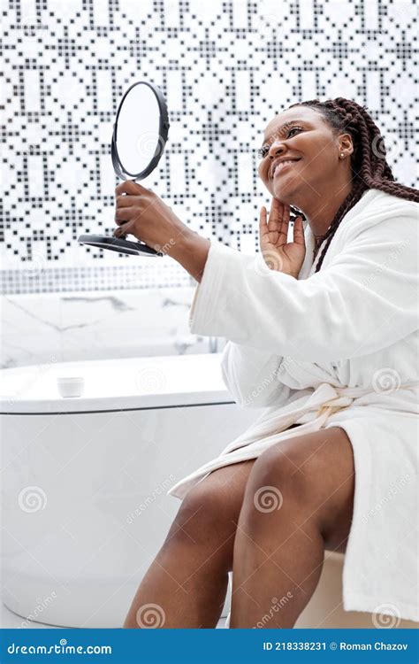 Side View On African Woman Sitting At Toilet And Touching Perfect Skin