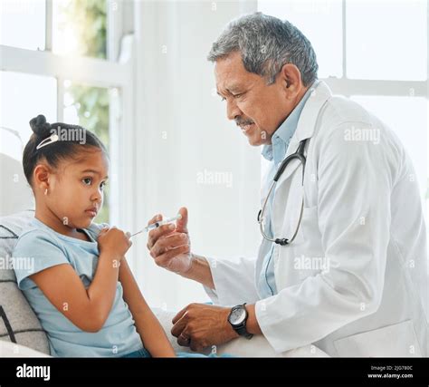 Its Better If You Look Away Shot Of A Mature Male Doctor Giving A