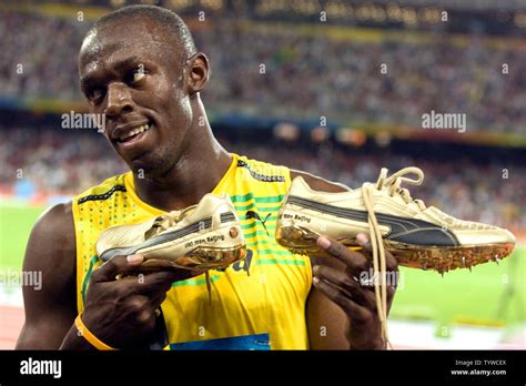 Jamaicas Usain Bolt Shows The Crowd His Golden Shoes After Smashing