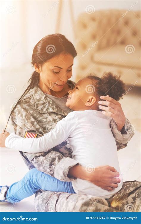 Gentle Mother Being About To Caress Her Daughters Hair Stock Image