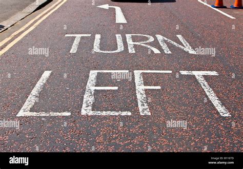 Turn Left Sign In Typical London Street Asphalt Stock Photo Alamy