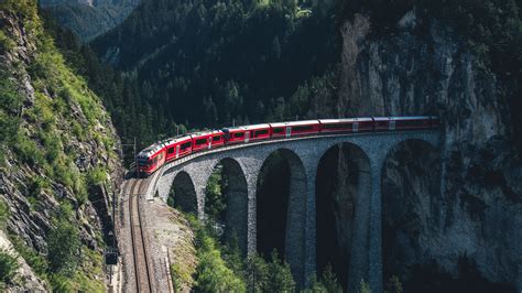 Download Wallpaper 2560x1440 Train Mountains Aerial View Bridge
