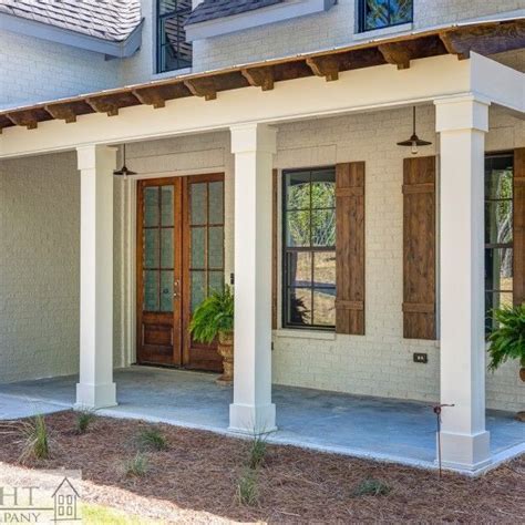 Front Porch With White Brick And Rustic Wooden Corbels Brick Columns